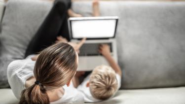 Parent Child Digital Safety Mother sitting with child learning at home on the computer.